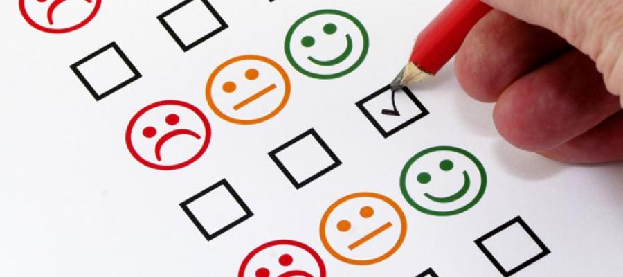person filling in a paper form tick box with a pencil