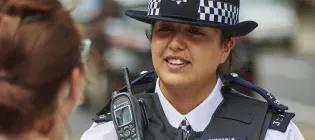 female police officer in uniform talks to someone