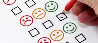 person filling in a paper form tick box with a pencil