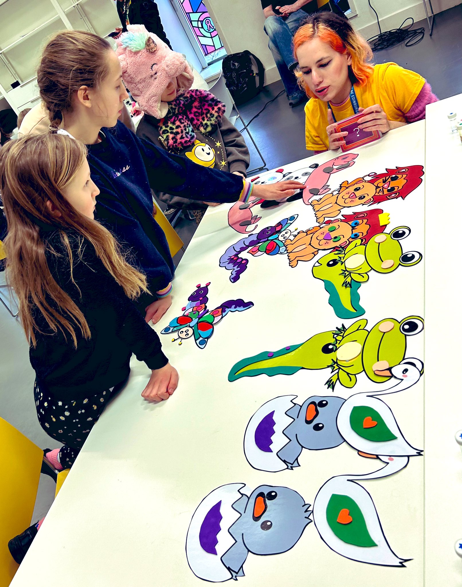 A researcher engages children in a colourful biology activity